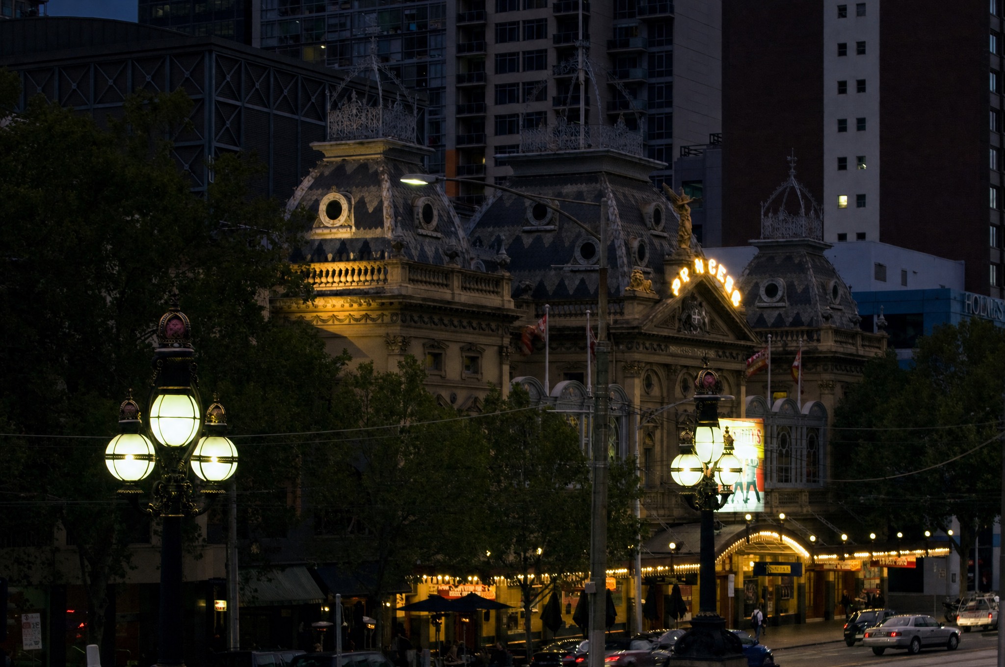 The Princess Theatre at night, its roof sign and marquee lit above Spring Street